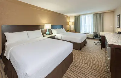 a hotel room with two beds and a desk at Best Western Plus Strongsville Cleveland in Strongsville