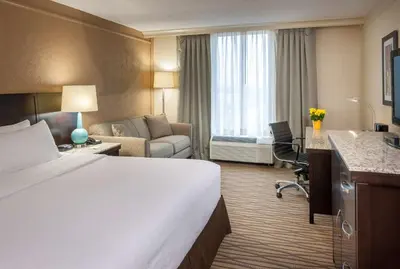 a hotel room with a bed and a living room at Best Western Plus Strongsville Cleveland in Strongsville