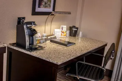 a hotel room table with a coffee maker on it at Best Western Plus Strongsville Cleveland in Strongsville