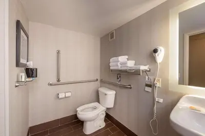 a bathroom with a toilet and a sink at Best Western Plus Strongsville Cleveland in Strongsville