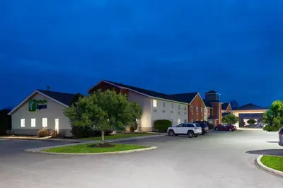 a row of houses with cars parked in a parking lot at Holiday Inn Express Vermilion by IHG in Vermilion