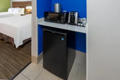 a room with a desk with a microwave and a refrigerator at Holiday Inn Express Vermilion by IHG in Vermilion