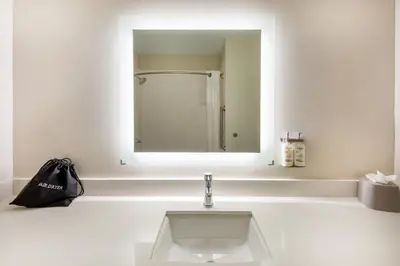 a white bathroom with a sink and a mirror at Holiday Inn Express Vermilion by IHG in Vermilion