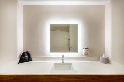 a white bathroom with a sink and a mirror at Holiday Inn Express Vermilion by IHG in Vermilion