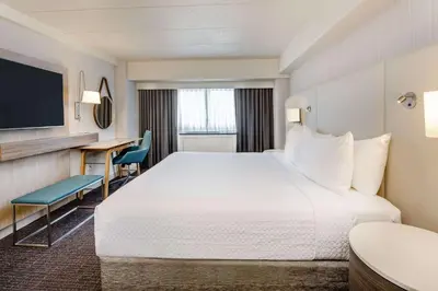 a hotel room with a large bed and a desk at Sonesta Columbus Downtown in Columbus