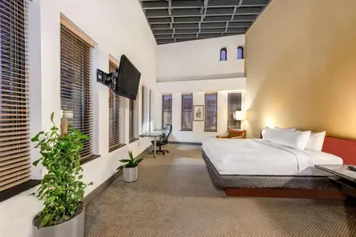 a bedroom with a bed and a desk and a tv at Sonesta Columbus Downtown in Columbus