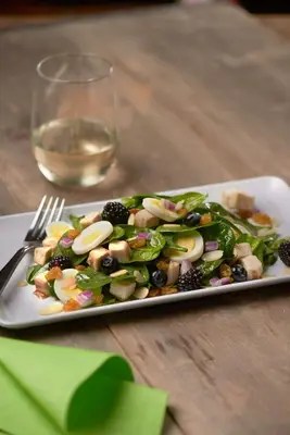 a plate of salad on a table with a glass of wine at Hyatt Place Cleveland/Lyndhurst/Legacy Village in Lyndhurst