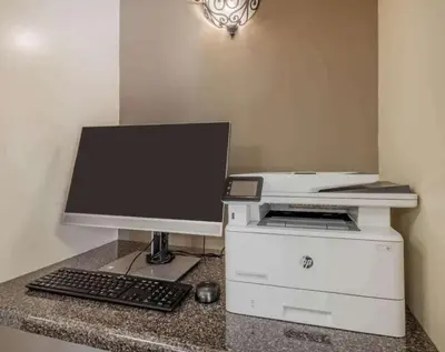 a computer monitor and a printer on a counter at Sonesta Simply Suites Columbus Airport Gahanna in Gahanna