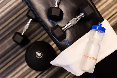 a bottle of water in a suitcase with a towel at Sonesta Simply Suites Columbus Airport Gahanna in Gahanna