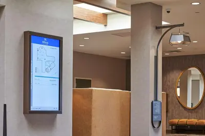 a projection screen on a wall in a lobby at Hilton Cincinnati Airport in Florence