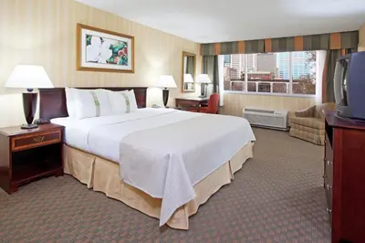 a hotel room with a large bed and a television at Holiday Inn Columbus Dwtn-Capitol Square by IHG in Columbus