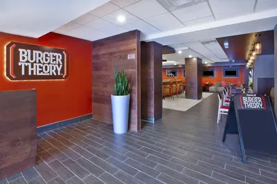 a restaurant with a burger theory sign on the wall at Holiday Inn Columbus Dwtn-Capitol Square by IHG in Columbus