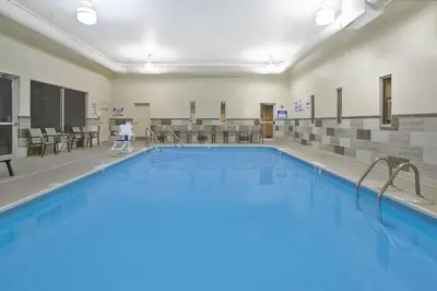 a large swimming pool with a person walking in front of it at Holiday Inn Columbus Dwtn-Capitol Square by IHG in Columbus