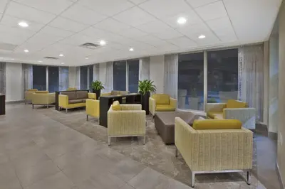 a waiting room with couches and chairs and windows at Holiday Inn Columbus Dwtn-Capitol Square by IHG in Columbus