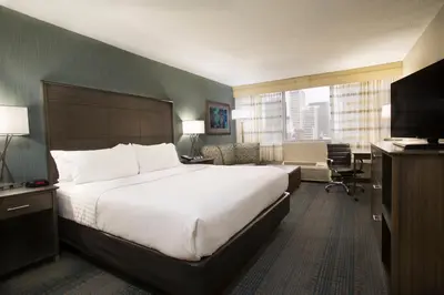 a hotel room with a large bed and a desk at Holiday Inn Columbus Dwtn-Capitol Square by IHG in Columbus