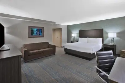 a hotel room with a bed and a couch at Holiday Inn Columbus Dwtn-Capitol Square by IHG in Columbus