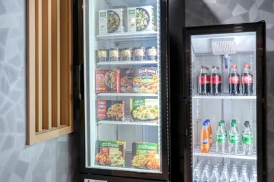 a refrigerator filled with lots of drinks and food at Holiday Inn Express Hotel & Suites Columbus Airport by IHG in Gahanna