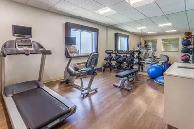 a fitness room with treadmills and exercise equipment at Holiday Inn Express Columbus - Ohio Expo Center by IHG in Columbus