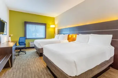 a hotel room with two beds and a television at Holiday Inn Express Columbus - Ohio Expo Center by IHG in Columbus