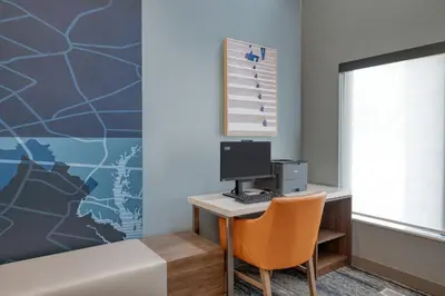 a room with a desk with a computer on a wall at Holiday Inn Express & Suites Wadsworth by IHG in Wadsworth