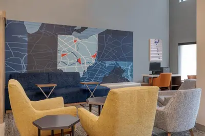a waiting room with chairs and a blue couch at Holiday Inn Express & Suites Wadsworth by IHG in Wadsworth