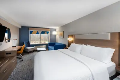 a hotel room with a large bed and a desk at Holiday Inn Express & Suites Wadsworth by IHG in Wadsworth