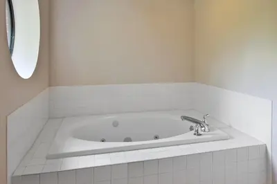 a white bath tub with a silver faucet in a bathroom at Holiday Inn Express Hotel & Suites Cincinnati Northeast-Milford by IHG in Milford