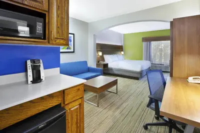 a hotel room with a kitchen and a living room at Holiday Inn Express Hotel & Suites Cincinnati Northeast-Milford by IHG in Milford