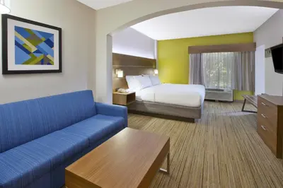 a hotel room with a bed and a couch at Holiday Inn Express Hotel & Suites Cincinnati Northeast-Milford by IHG in Milford