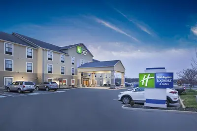 a hotel with cars parked in a parking lot at Holiday Inn Express Hotel & Suites Circleville by IHG in Circleville