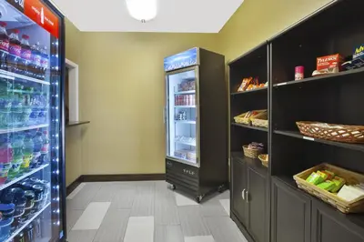 a kitchen with a refrigerator with drinks in it at Holiday Inn Express Hotel & Suites Circleville by IHG in Circleville
