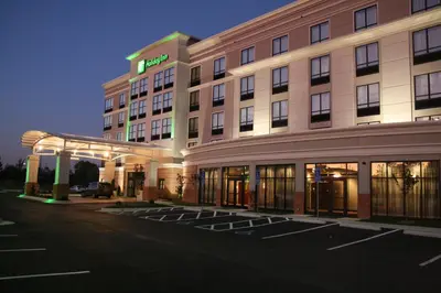 a hotel with a parking lot in front of it at Holiday Inn Columbus-Hilliard by IHG in New Rome