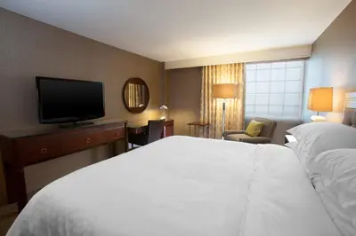 a hotel room with a bed and a flat screen tv at Sheraton Pittsburgh Airport Hotel in Coraopolis
