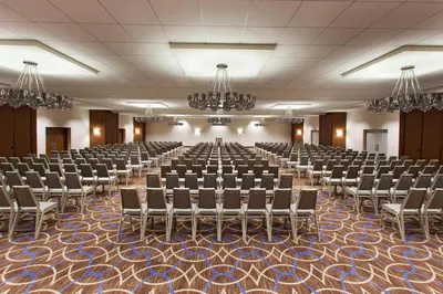 a large room with rows of chairs and chandeliers at Sheraton Pittsburgh Airport Hotel in Coraopolis