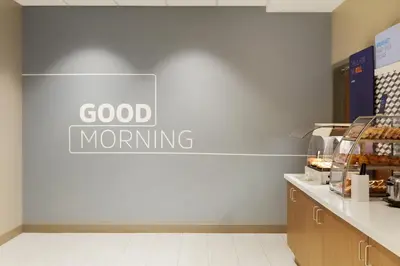 a sign that reads good morning on a wall in a bakery at Holiday Inn Express Hotel & Suites Grove City by IHG in Grove City