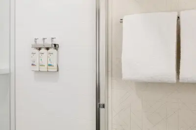 a bathroom with a shower stall with a towel at Holiday Inn Express Hotel & Suites Grove City by IHG in Grove City