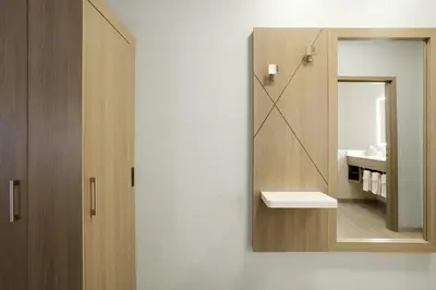 a bathroom with a mirror and a sink at Holiday Inn Express Hotel & Suites Grove City by IHG in Grove City