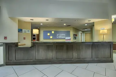 a waiting area in a hospital with a large screen at Holiday Inn Express Hotel & Suites Grove City by IHG in Grove City