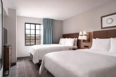 a hotel room with two beds and a window at Staybridge Suites Akron-Stow-Cuyahoga Falls by IHG in Stow