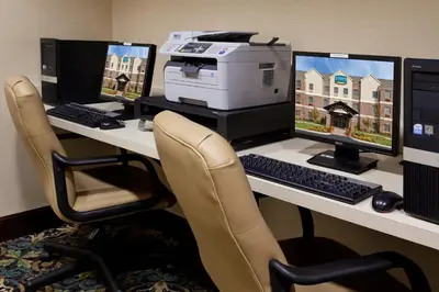 a desk with two computer monitors and a printer at Staybridge Suites Akron-Stow-Cuyahoga Falls by IHG in Stow