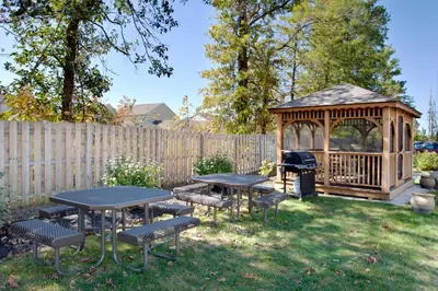a backyard with a gazebo and picnic tables and a grill at Candlewood Suites Polaris by IHG in Columbus