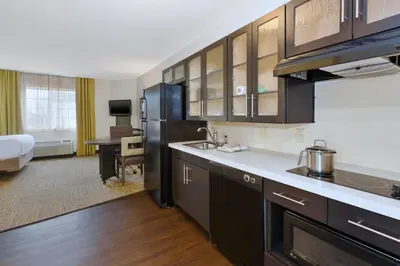 a kitchen with a sink and a refrigerator in a room at Candlewood Suites Polaris by IHG in Columbus