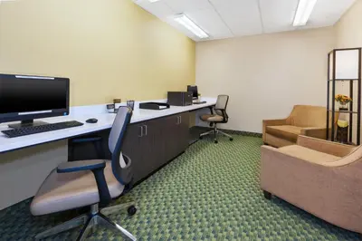 an office with a desk with a computer and two chairs at Candlewood Suites Polaris by IHG in Columbus