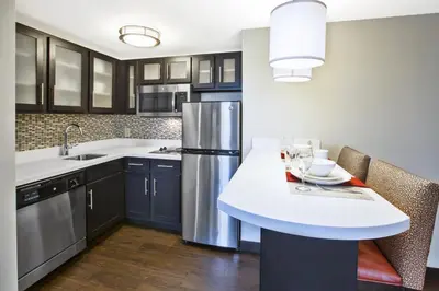 a kitchen with blue cabinets and a white counter top at Staybridge Suites Cleveland Mayfield Heights Beachwood by IHG in Mayfield Heights