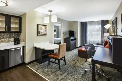a hotel room with a kitchen and a living room at Staybridge Suites Cleveland Mayfield Heights Beachwood by IHG in Mayfield Heights