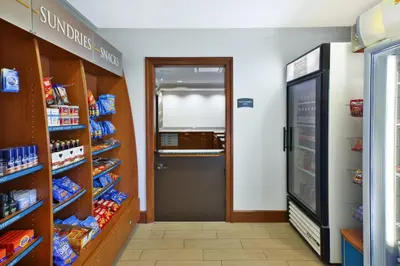 a grocery store aisle with a door to a store with food at Staybridge Suites Cleveland Mayfield Heights Beachwood by IHG in Mayfield Heights