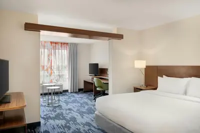 a hotel room with a bed and a desk at Fairfield Inn & Suites by Marriott Cincinnati Uptown/University Area in Cincinnati