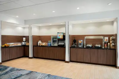 a lobby with a cafeteria with a food counter at Fairfield Inn & Suites by Marriott Cincinnati Uptown/University Area in Cincinnati