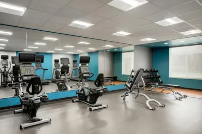 a gym with several treadmills and exercise bikes at Fairfield Inn & Suites by Marriott Cincinnati Uptown/University Area in Cincinnati