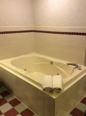 a bathroom with a tub with two towels on it at Americas Best Value Inn of Decatur in Decatur